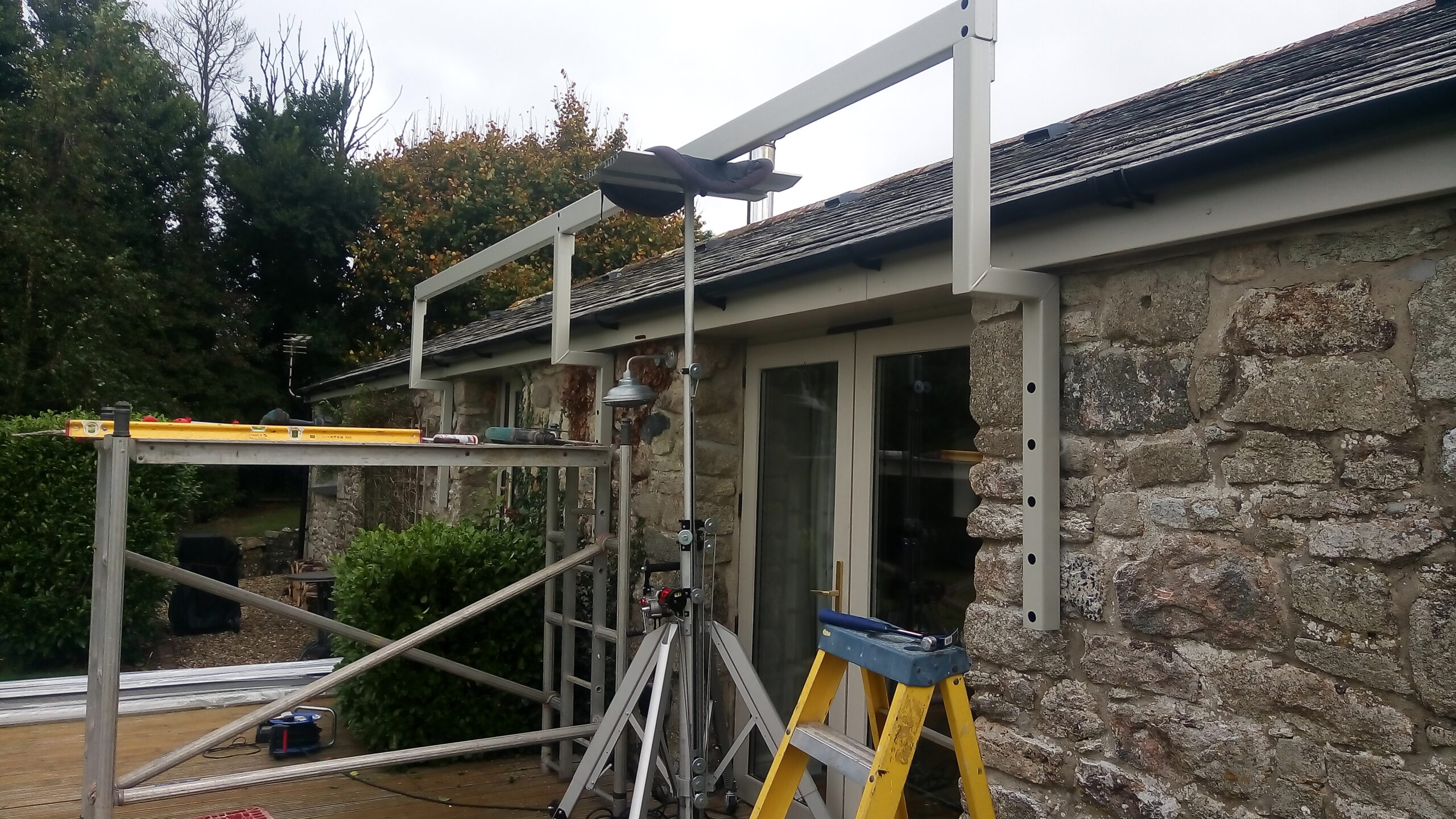 Brackets and beam for Veranda canopy with glass roof and powder coated in silk grey RAL7044 located in Newquay, Cornwall, provided by All Weather Canopies South West Limited.
