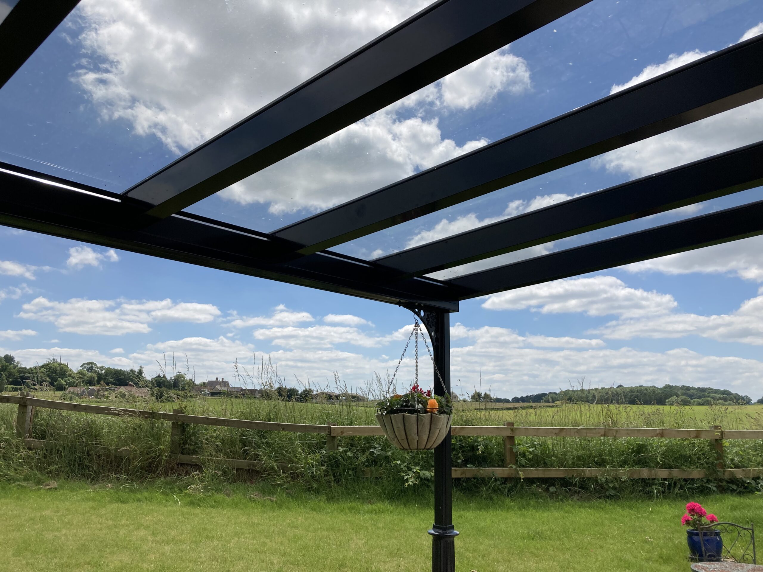 Jet black Victorian-style canopy with a glass roof, showcasing a modern design.
