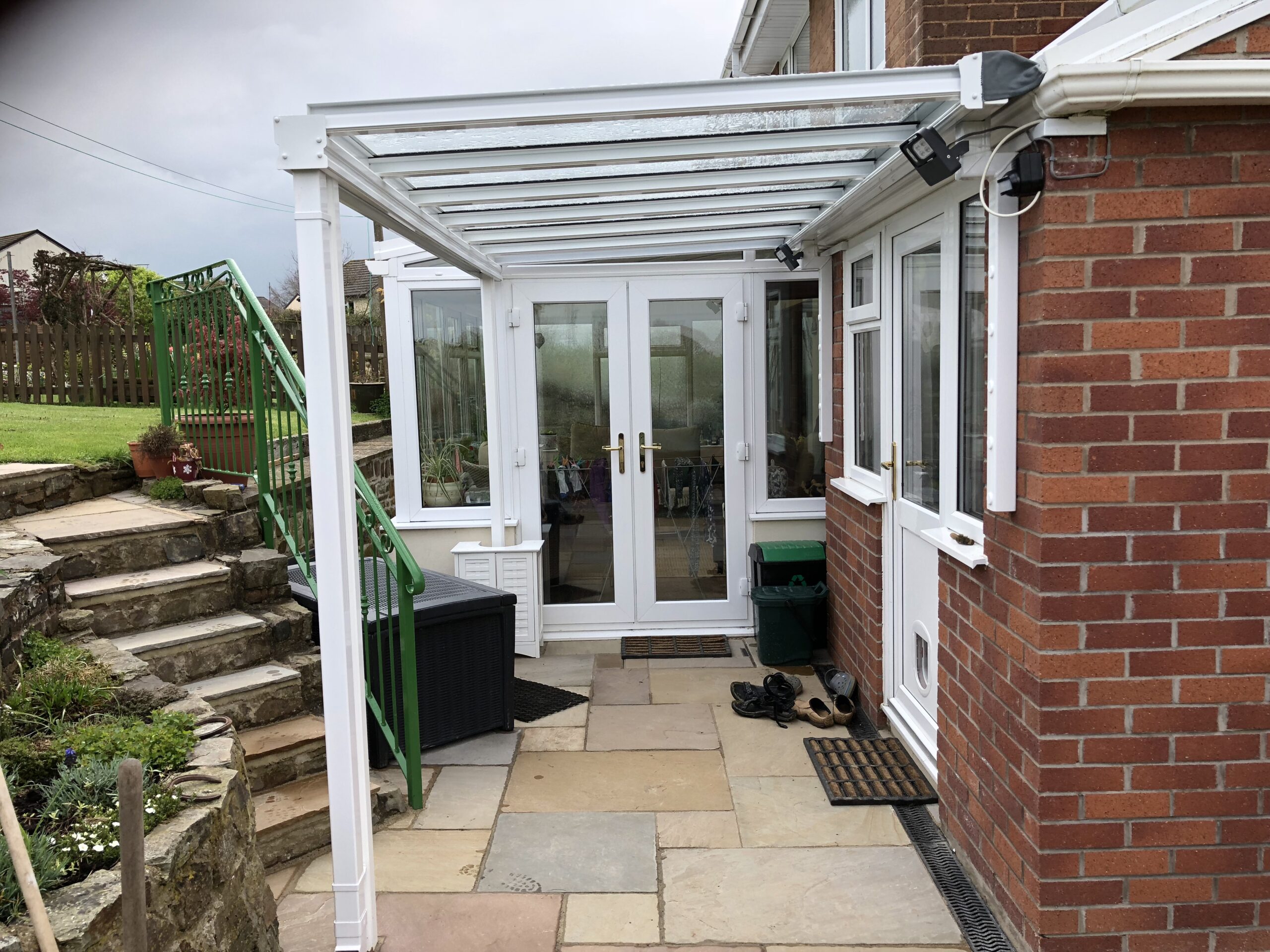 Veranda canopy with a glass roof attached to a brick building in Chittlehampton, Devon.